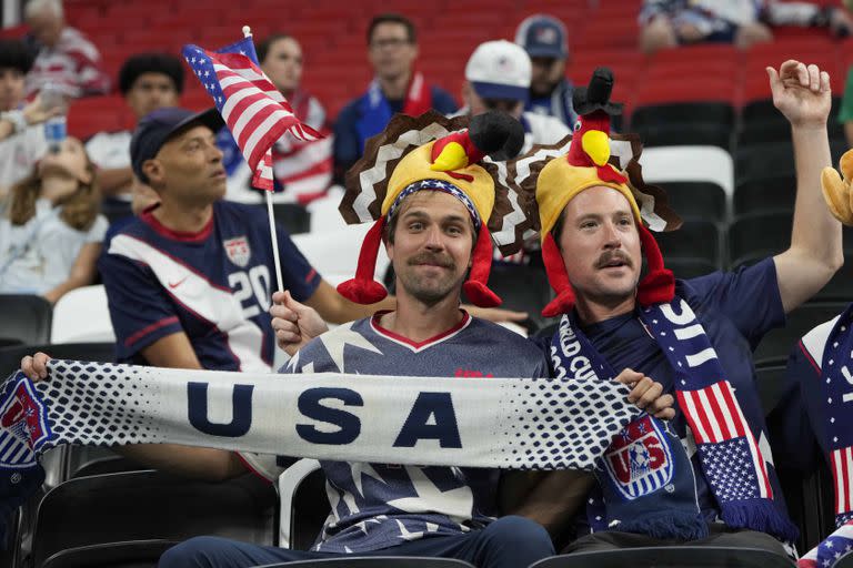 U.S. team supporters cheer for their team prior to the World Cup group B soccer match between England and The United States, at the Al Bayt Stadium in Al Khor, Qatar, Friday, Nov. 25, 2022. (AP Photo/Andre Penner)