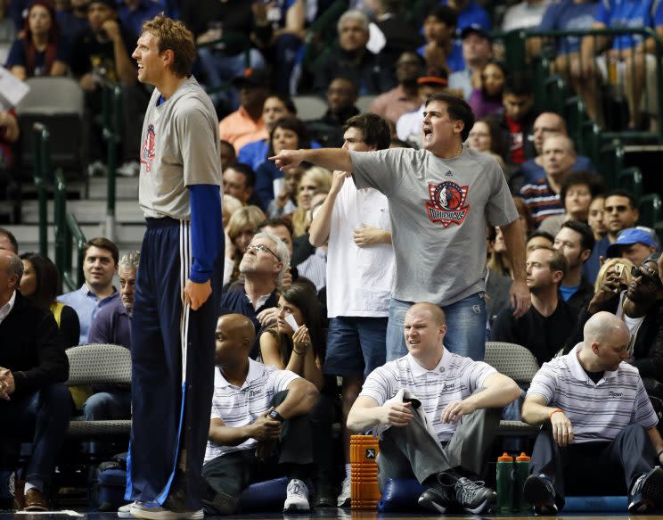 Mark Cuban points as Dirk Nowitzki looks on. (AP)