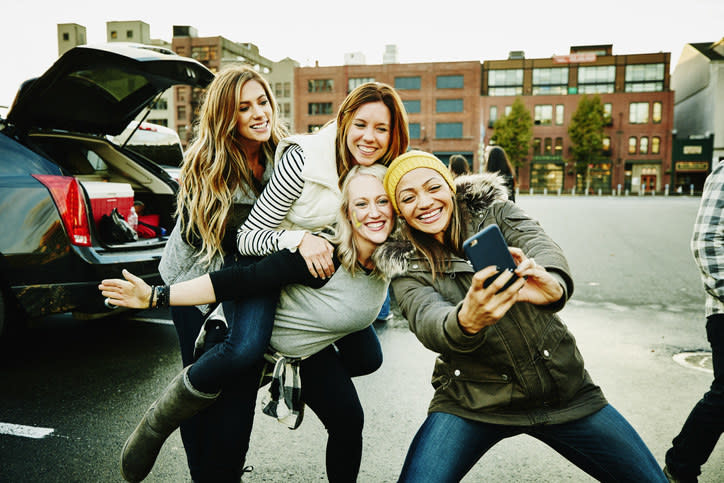 teens in the parking lot taking selfies