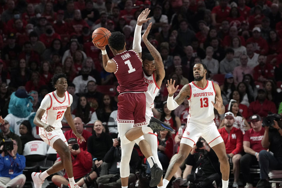 Temple's Damian Dunn (1) is fouled by Houston's Reggie Chaney as he shoots during the first half of an NCAA college basketball game Sunday, Jan. 22, 2023, in Houston. (AP Photo/David J. Phillip)