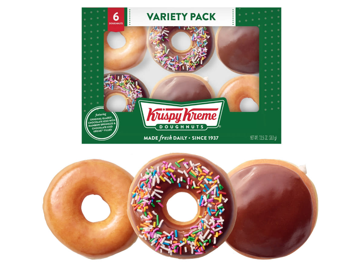 box of krispy kreme doughnuts above three doughnuts