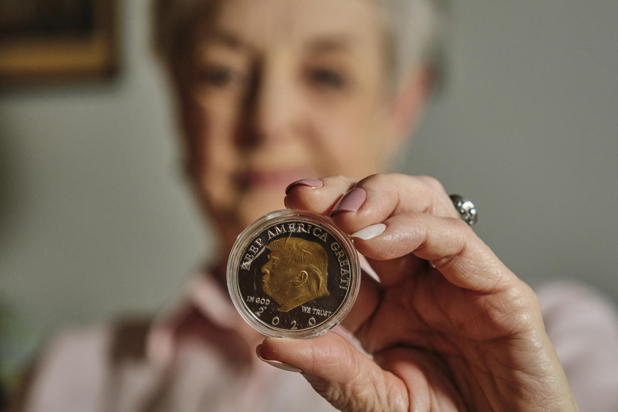 An Alabama grandmother holds one of the coins she bought online in her apartment in Mobile. (Dan Anderson for NBC News)