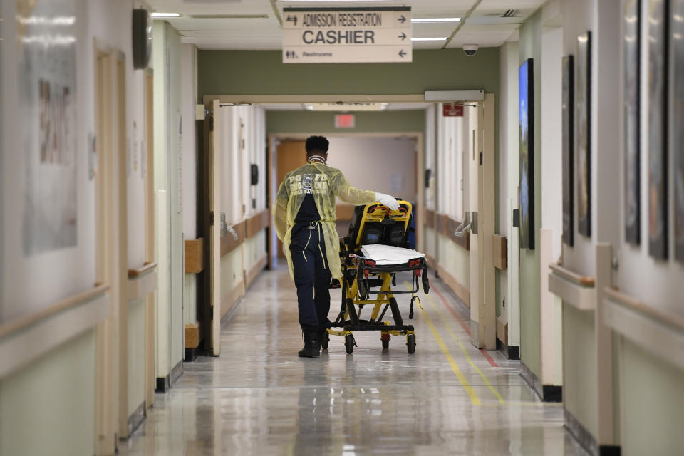 A Prince George County firefighter walks the halls of UM Laurel Medical Center in Laurel, Md., Friday, April 17, 2020. The hospital is reopening on Monday to treat coronavirus patients. While the main part of the Hospital closed, the Emergency Room remains open. (AP Photo/Susan Walsh)
