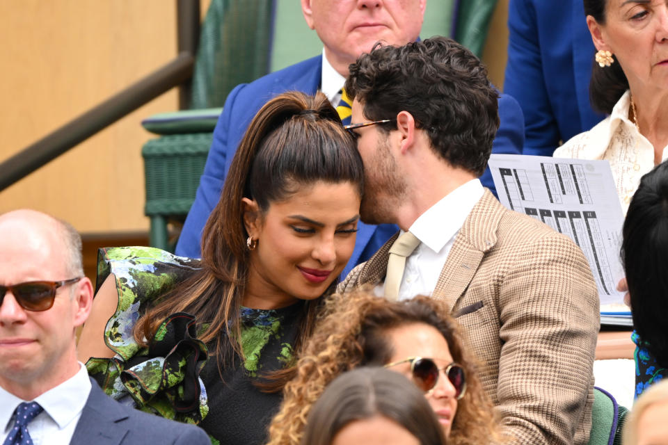 Nick saying something to Priyanka, who's leaning in