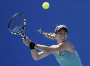 Eugenie Bouchard of Canada hits a return to Tang Haochen of China during their women's singles match at the Australian Open 2014 tennis tournament in Melbourne January 13, 2014. REUTERS/Brandon Malone (AUSTRALIA - Tags: SPORT TENNIS)