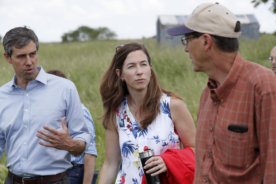 Democratic presidential candidate Beto O'Rourke, left, and his wife Amy, center, talk with Matt Russell, right, while touring his Coyote Run Farm, Friday, June 7, 2019, in Lacona, Iowa. (AP Photo/Charlie Neibergall)