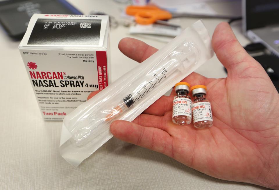 Two forms of Naloxone, a nasal spray and an intramuscular injection, are shown.