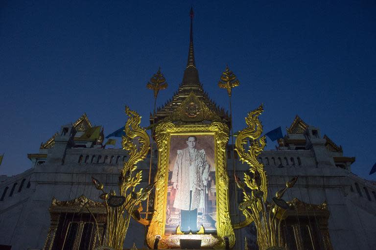 Thais hold great affection for King Bhumibol Adulyadej, and a poster of the monarch is displayed at the Wat Trimitr temple in Bangkok