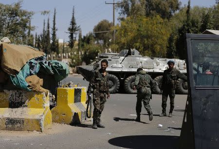 Police troopers secure the entrance of the U.S. embassy in Sanaa February 11, 2015. REUTERS/Khaled Abdullah