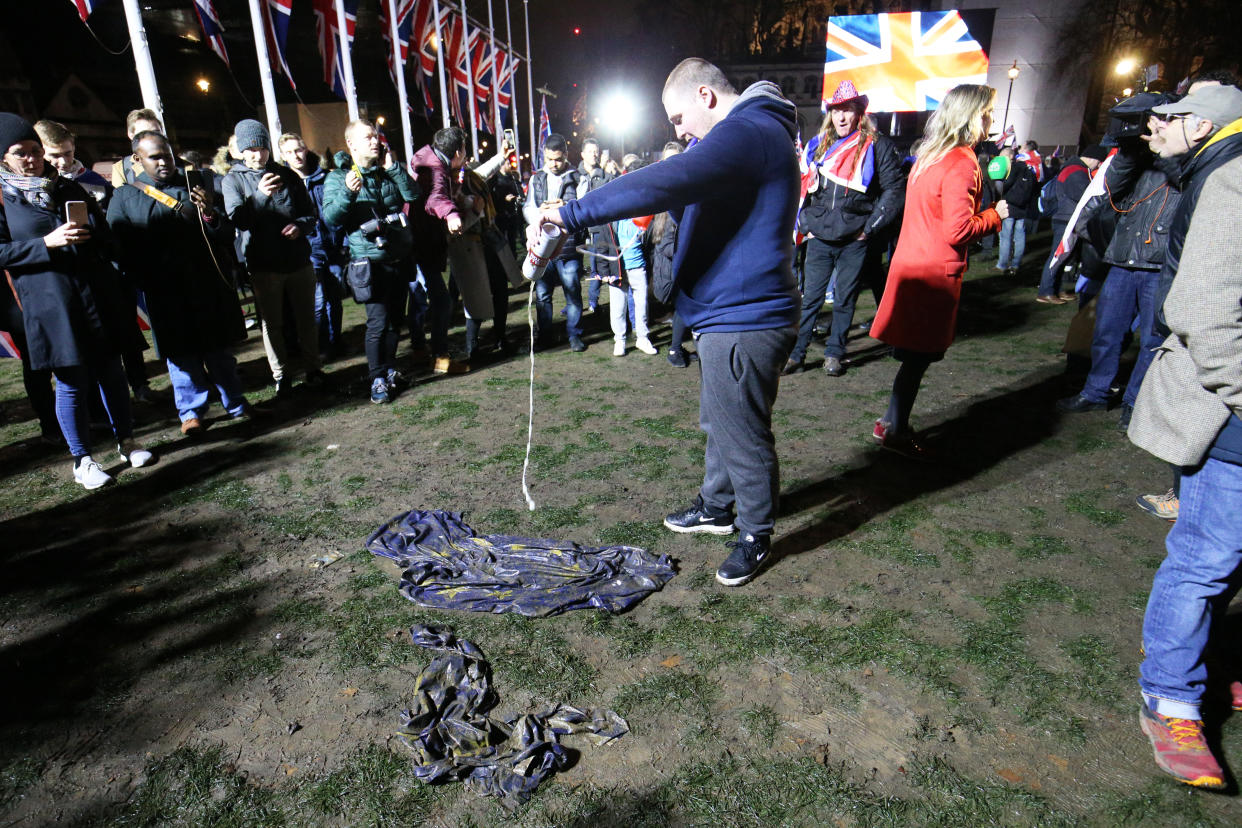 A pro-Brexit supporter pours beer onto an EU flag in Parliament Square, London, ahead of the UK leaving the European Union at 11pm on Friday.