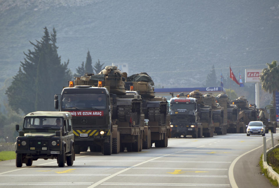 A convoy of Turkish military trucks carrying tanks and armoured personnel carriers destined for Syria in preparation for a possible military offensive, moves in Hatay province, southeastern Turkey, near the border with Syria, Monday, Jan. 14, 2019. U.S. Secretary of State Mike Pompeo said Monday that U.S. President Donald Trump's threat to devastate NATO ally Turkey's economy if it attacks U.S.-backed Kurdish fighters in Syria underscores America's commitment to its partners. (Mehmet Kocacik/Kirikhan/DHA via AP)