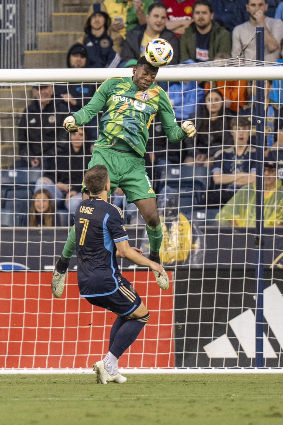 Toronto FC's Sean Johnson, top, heads the ball away from Philadelphia Union's Mikkel Uhre during the first half of an MLS soccer match, Wednesday, May 29, 2024, in Chester, Pa. (AP Photo/Chris Szagola)