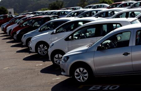 Vehicles sit parked in a lot at a General Motors vehicle factory in Sao Jose dos Campos near Sao Paulo, February 23, 2015. REUTERS/Roosevelt Cassio