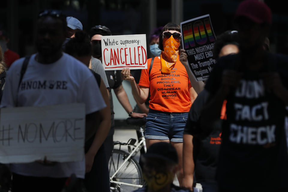 Protesters gather on Federal Plaza Thursday, July 23, 2020, after a collection of Chicago activists groups announced they are filing a federal lawsuit against the Chicago Police Department, Fraternal Order of Police, and the federal government, in Chicago. The lawsuit also asks a judge to prevent agents in Chicago from making arrests or detaining people without probable cause and to require agents to identify themselves and their agency before taking either action and explain why someone is being arrested. (AP Photo/Charles Rex Arbogast)