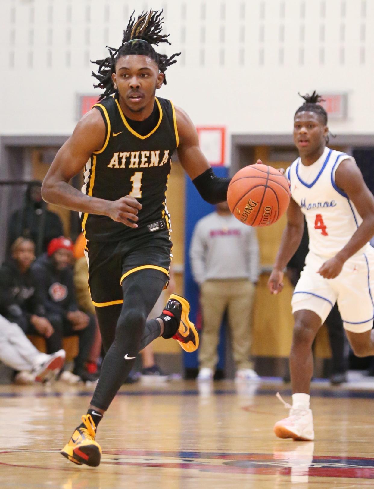 Greece Athena senior guard Khorie Reaves starts the fast break up court ahead of Monroe's Tajmir Mullins during their Section V boys basketball game Monday, Dec. 18, 2023 at James Monroe High School in Rochester.