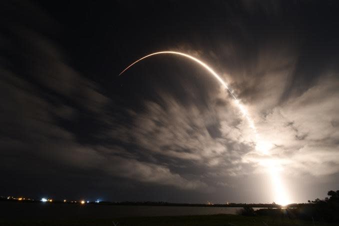 A time exposure captures the fiery trajectory of a SpaceX Falcon 9 rocket climbing away from the Cape Canaveral Air Force Station carrying 60 Starlink internet relay satellites. It was the company's 23rd launch so far this year, the 100th for the workhorse Falcon 9 since the rocket's debut in 2010 and a record seventh flight for the booster's first stage. / Credit: William Harwood/CBS News