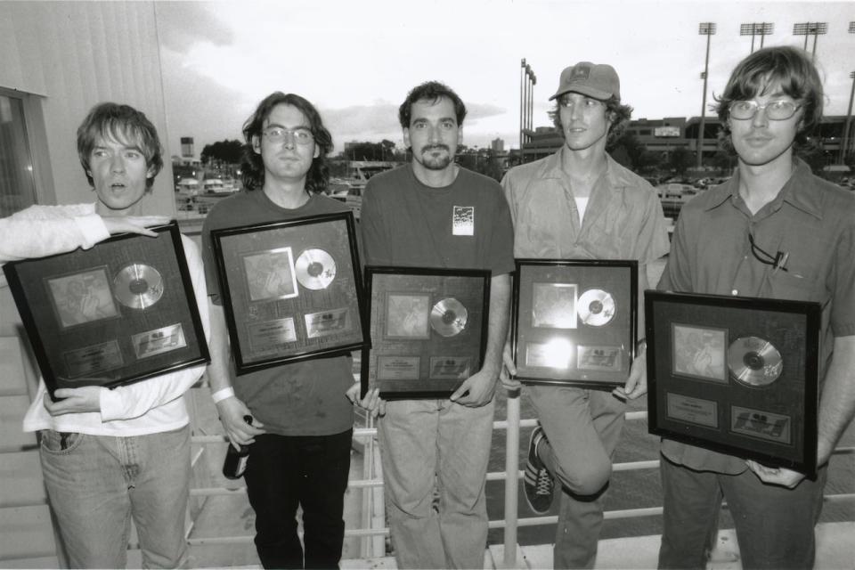 Chip Sutherland is shown with the members of Sloan getting gold records in 1995 for the band's first album, Smeared. From left: Jay Ferguson, Patrick Pentland, Chip Sutherland, Andrew Scott and Chris Murphy.