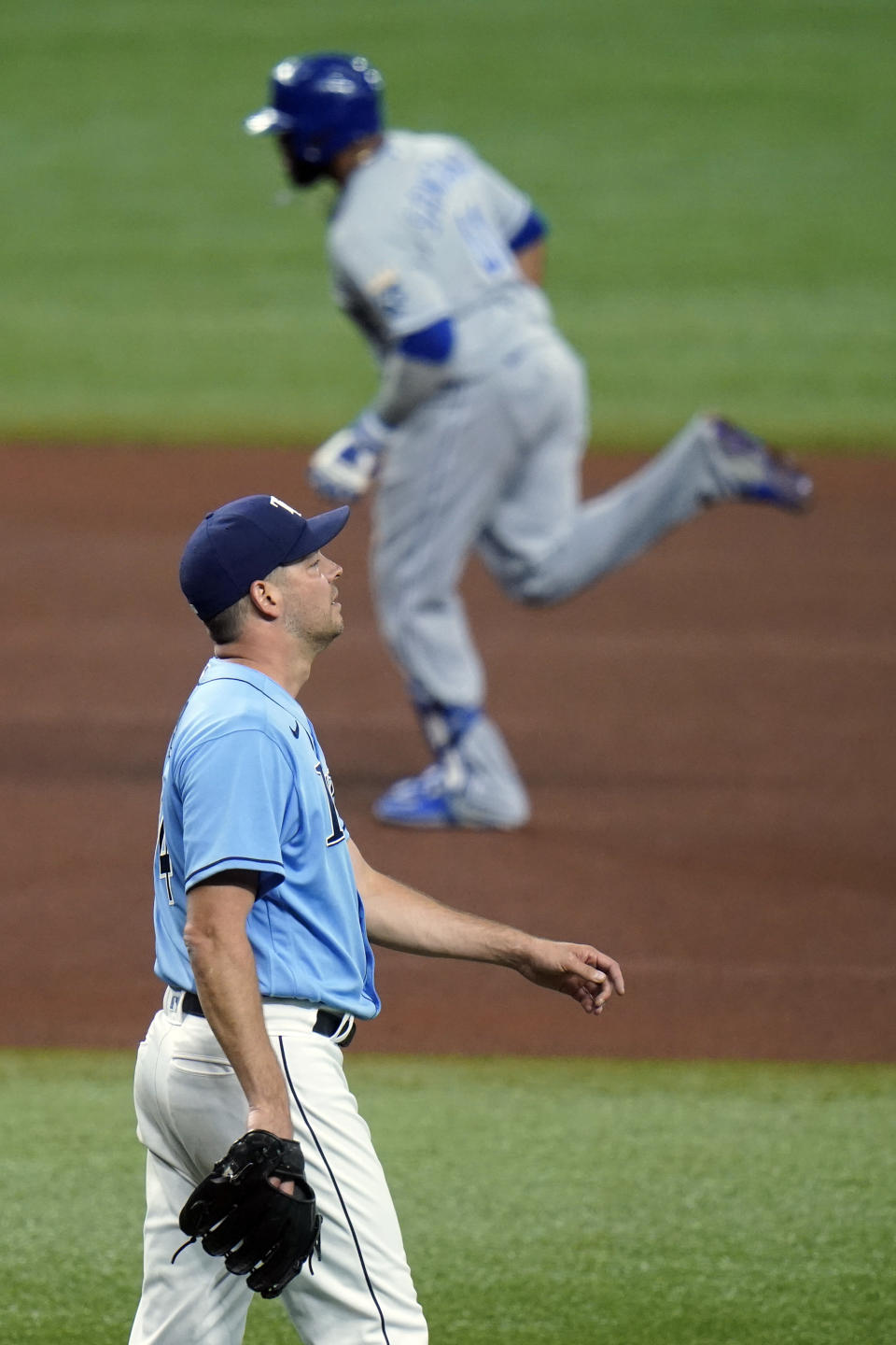 Tampa Bay Rays starting pitcher Rich Hill reacts as Kansas City Royals' Carlos Santana runs around the bases following his solo home run during the fourth inning of a baseball game Tuesday, May 25, 2021, in St. Petersburg, Fla. (AP Photo/Chris O'Meara)