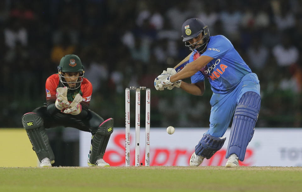 India’s Rohit Sharma plays a shot against Bangladesh as Mushfiqur Rahim watches during the final match of the Nidahas triangular Twenty20 cricket series in Colombo, Sri Lanka, Sunday, March 18, 2018. (AP Photo/Eranga Jayawardena)