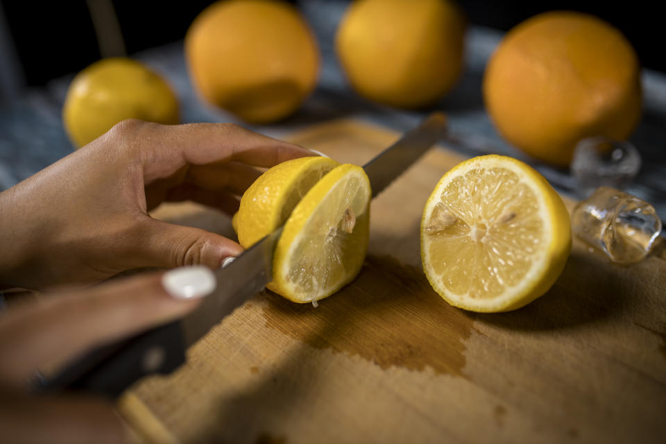 Lemons and oranges cut for juice pressing and decoration in a bar.