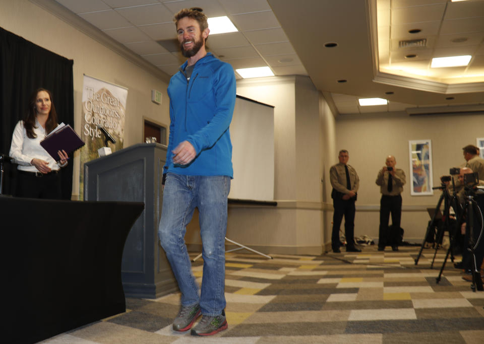 Travis Kauffman enters a news conference Thursday, Feb. 14, 2019, in Fort Collins, Colo., about his encounter with a mountain lion while running a trail just west of Fort Collins last week. (AP Photo/David Zalubowski)