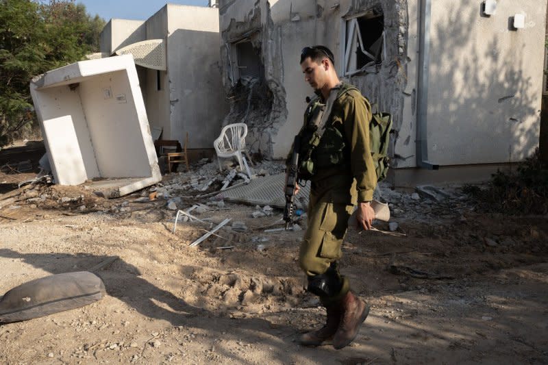 An Israeli soldier walks past a destroyed Jewish home in the Jewish community of Kfar Azza on Sunday, November 5, 2023. This community is close to the border with the Gaza Strip and on October 7, 2023 the Hamas terrorists infiltrated here and killed some 59 Israelis. Photo by Jim Hollander/UPI