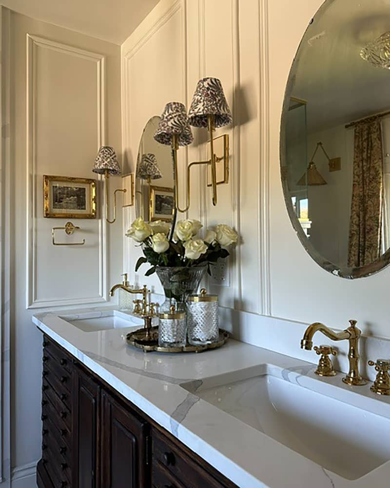 Brass faucet in double sink of newly renovated bathroom.