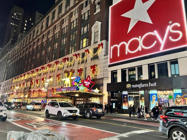 Shoppers browse Coach handbags in the Macy's Herald Square