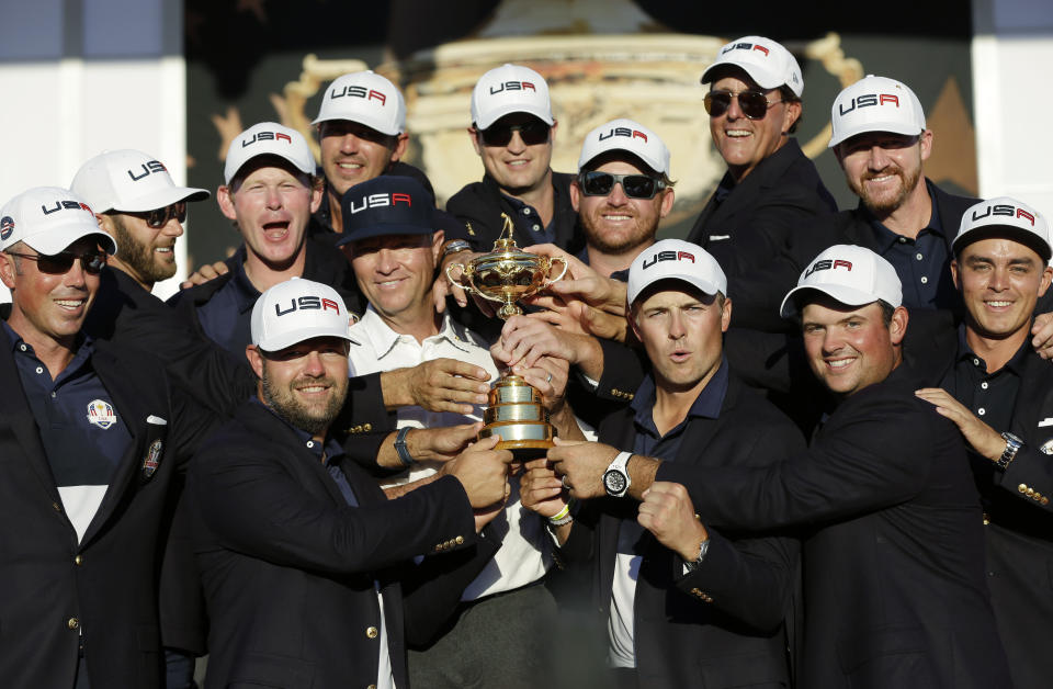 FILE - In this Oct. 2, 2016, file photo, United States captain Davis Love III, center left, is surrounded by his players as they pose for a picture during the closing ceremony of the Ryder Cup golf tournament at Hazeltine National Golf Club in Chaska, Minn. Hazeltine has a recent history of shockers, whether it was Rich Beem or Y.E. Yang winning the PGA Championship or the Americans winning the Ryder Cup. Now it hosts the Women's PGA Championship, a major that is rising to the top with the courses it plays. (AP Photo/David J. Phillip, File)