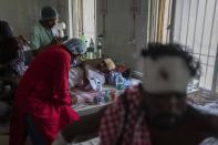 A passenger who was injured in Friday's train accident is examined by doctors at a hospital in Balasore district, in the eastern state of Orissa, India, Sunday, June 4, 2023. The train derailment in eastern India that killed more than 300 people and injured hundreds more was caused by an error in the electronic signaling system that led a train to wrongly change tracks, India’s railways minister said Sunday. (AP Photo/Rafiq Maqbool)