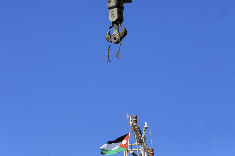 CORRECTS DAY TO TUESDAY - A snapped cable hangs from a crane at the site of a toxic gas explosion in Jordan's Red Sea port of Aqaba, Tuesday, June 28, 2022. A crane loading chlorine tanks onto a ship on Monday dropped one of them, causing an explosion of toxic yellow smoke that killed over a dozen people and sickened some 250, authorities said. (AP Photo/Raad Adayleh)