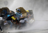 <p>Demonstrators clash with riot security forces while rallying against President Nicolas Maduro in Caracas, Venezuela, May 27, 2017. (Carlos Barria/Reuters) </p>