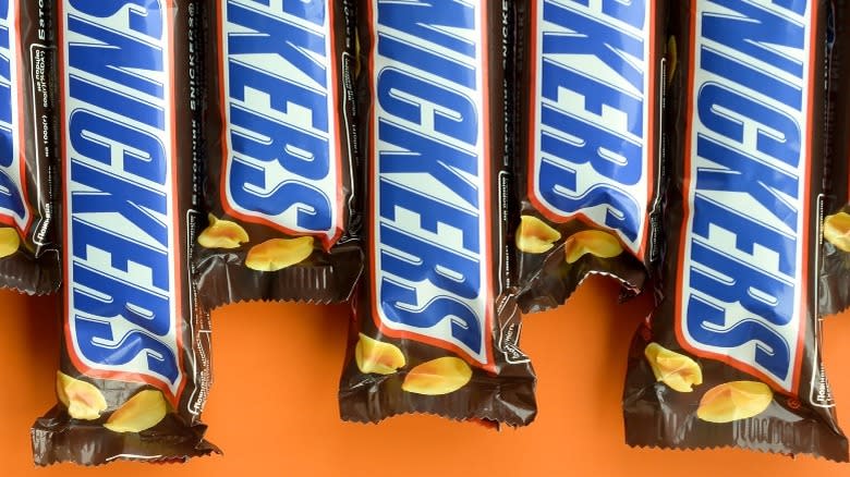 Snickers bars against orange background