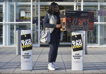 A shopper purchases a stereo system on Black Friday at a store in Croydon, south London, Britain, November 25, 2016. REUTERS/Hannah McKay