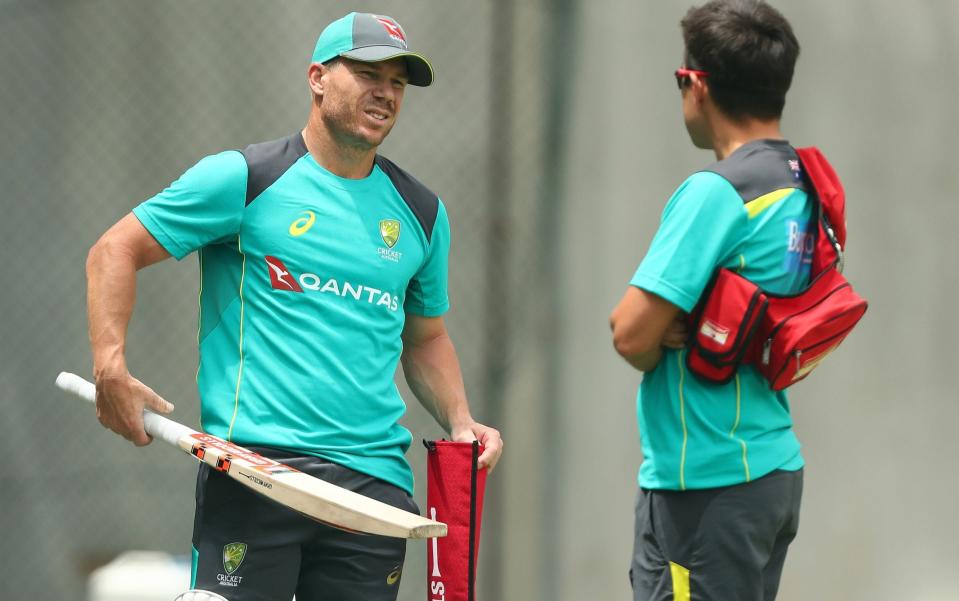 David Warner speaks to a team doctor during the nets session - Getty Images AsiaPac