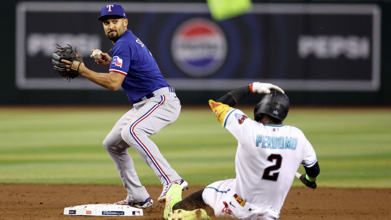  Texas Rangers' Marcus Semien and Arizona Diamondbacks' Geraldo Perdomo. 