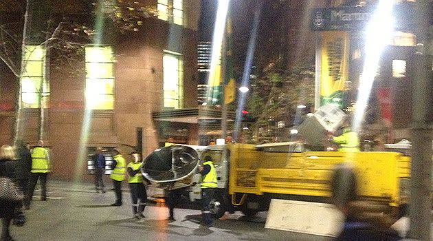 FIRST ON 7: Council workers remove a large satelitte dish from the Occupy Sydney camp in Martin Place. Photo: 7News