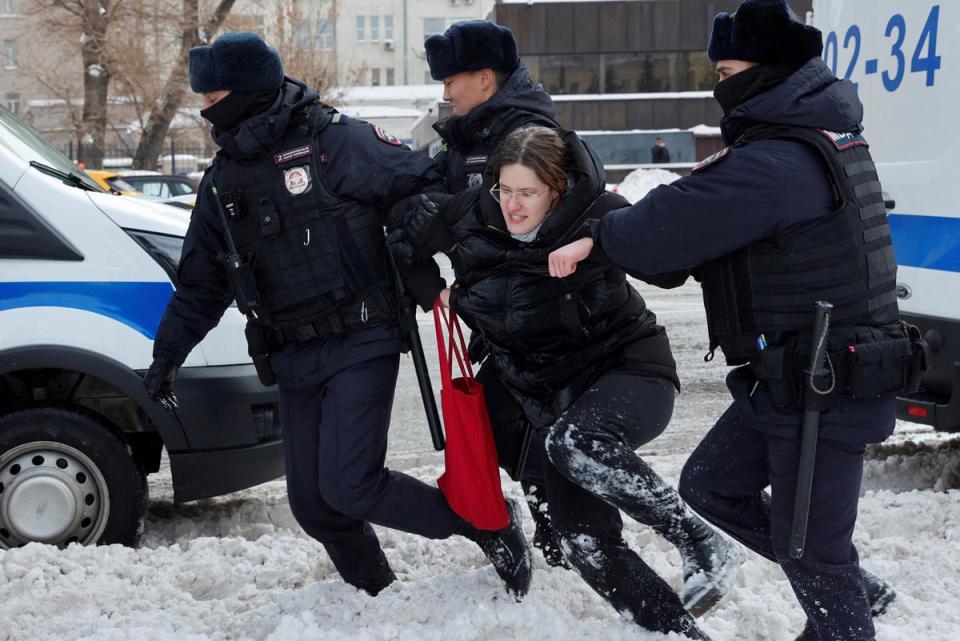 Police officers detain a woman during a gathering in memory of Russian opposition leader Alexei Navalny last month (Reuters)