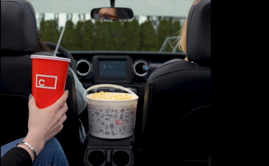 Drive-in visitors are shown with concession snacks in their vehicle in this image from a promotional video for Getty Drive-In in Muskegon.