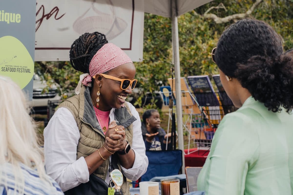 Lola Campbell, owner of Binya HHI, talking to customers at Hilton Head Seafood festival