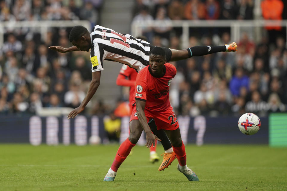 Newcastle United's Alexander Isak, top, and Brighton and Hove Albion's Moises Caicedo battle for the ball during the English Premier League soccer match between Brighton and Hove Albion and Newcastle United at St. James' Park, Newcastle, England, Thursday May 18, 2023. (Owen Humphreys/PA via AP)