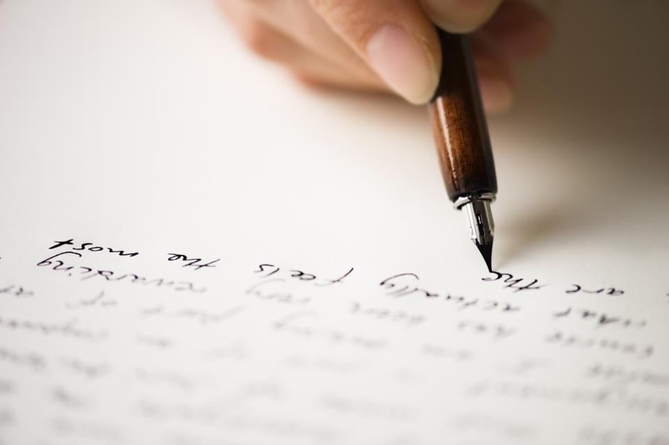 Writing letter to a friend. Selective focus and shallow depth of field.