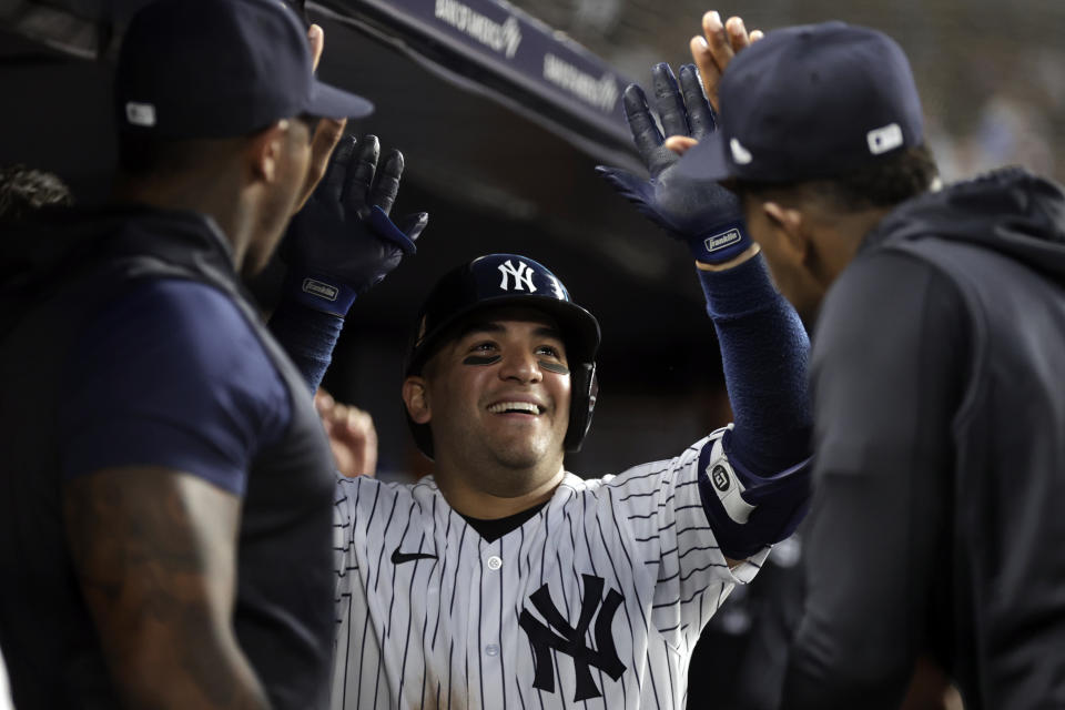 New York Yankees' Jose Trevino celebrates with teammates after hitting a home run during the fifth inning of a baseball game against the Chicago Cubs, Saturday, June 11, 2022, in New York. (AP Photo/Adam Hunger)