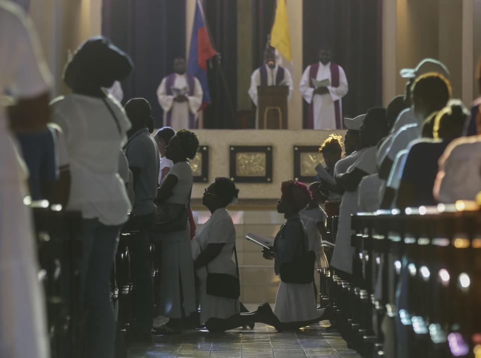 Faithful kneel in prayer during a Good Friday service as part of Holy Week celebrations, at the Saint Pierre Catholic church in the Pétion-Ville neighborhood of Port-au-Prince, Haiti, Friday, March 29, 2024. Holy Week commemorates the last week of Jesus Christ’s earthly life which culminates with his crucifixion on Good Friday and his resurrection on Easter Sunday. (AP Photo/Odelyn Joseph)