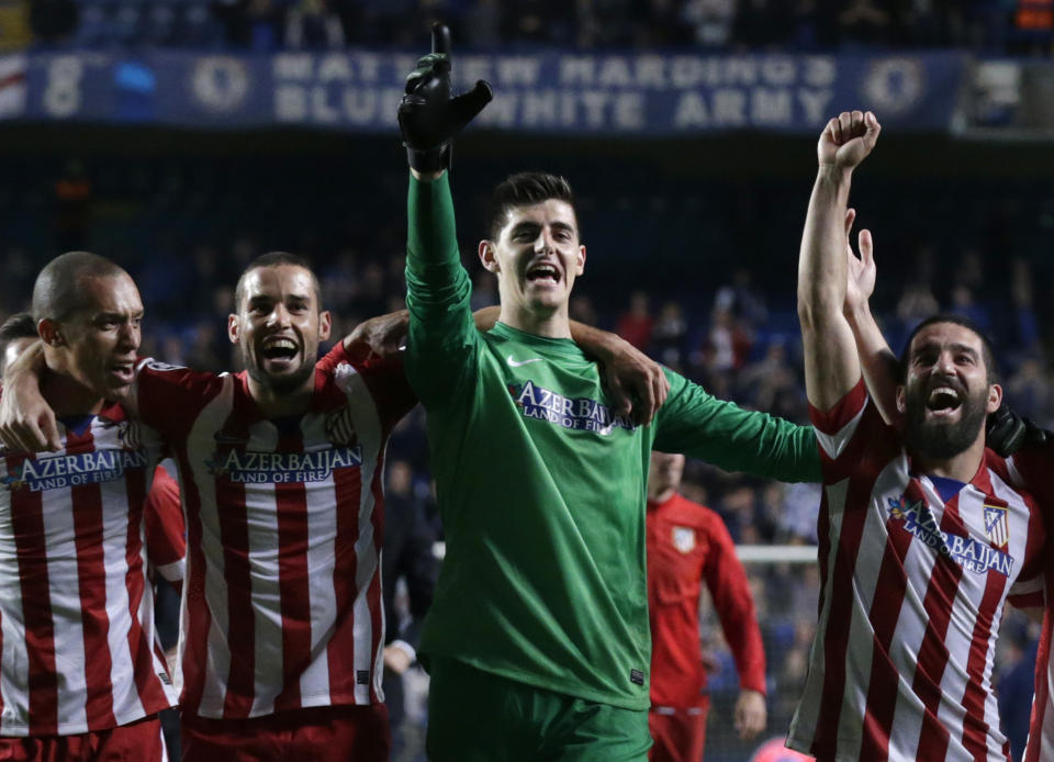 Members of the Atletico Madrid team celebrate in front of their fans after defeating Chelsea in the Champions League semifinal second leg soccer match between Chelsea and Atletico Madrid at Stamford Bridge stadium in London, Wednesday, April 30, 2014. (AP Photo/Matt Dunham)