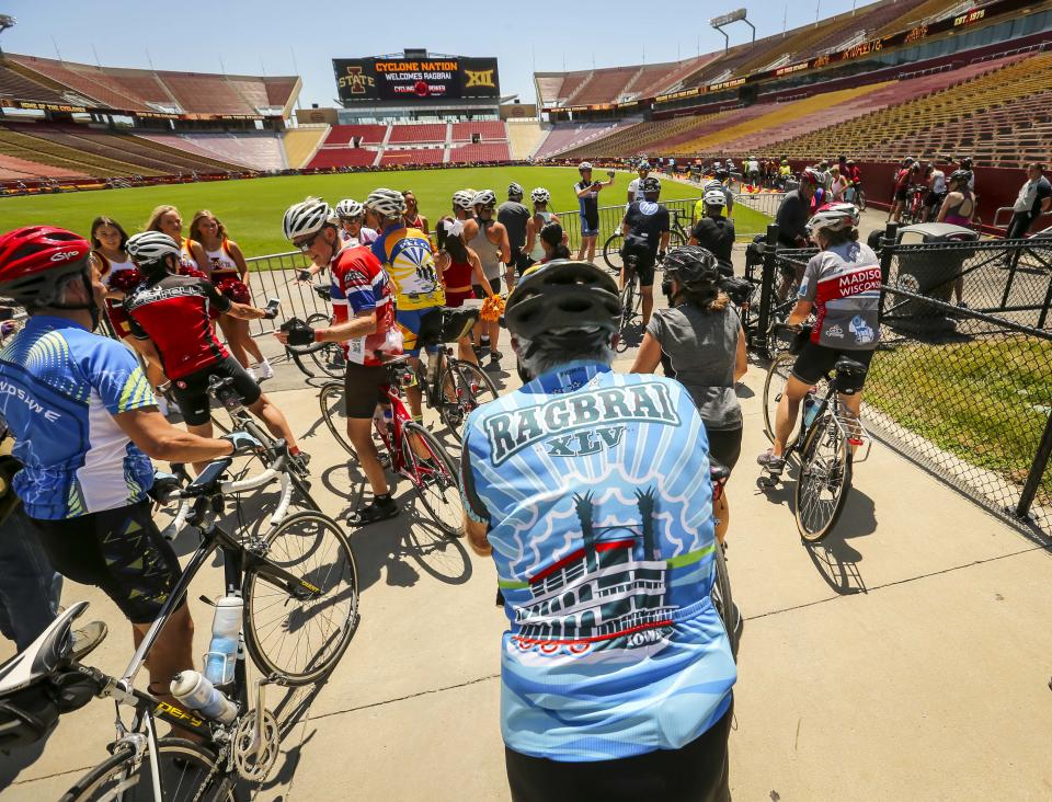 Riders enter onto the floor of Jack Trice Stadium at Iowa State University at the end of the route on July 24, in the overnight town of Ames, for RAGBRAI 2018.