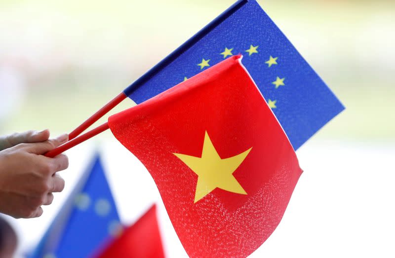 FILE PHOTO: European Union and Vietnamese flags are seen at the signing ceremony of EU-Vietnam Free Trade Agreement at the government office in Hanoi