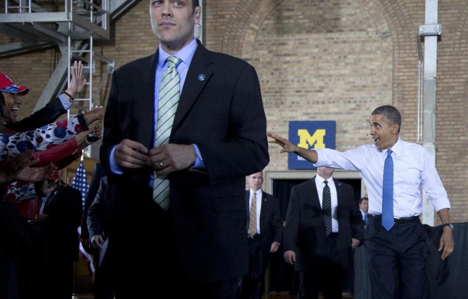 President Barack Obama waves as he arrives to speak at the University of Michigan, Wednesday, April 2, 2014, in Ann Arbor, Mich., about his proposal to raise the national minimum wage. (AP Photo/Carolyn Kaster)