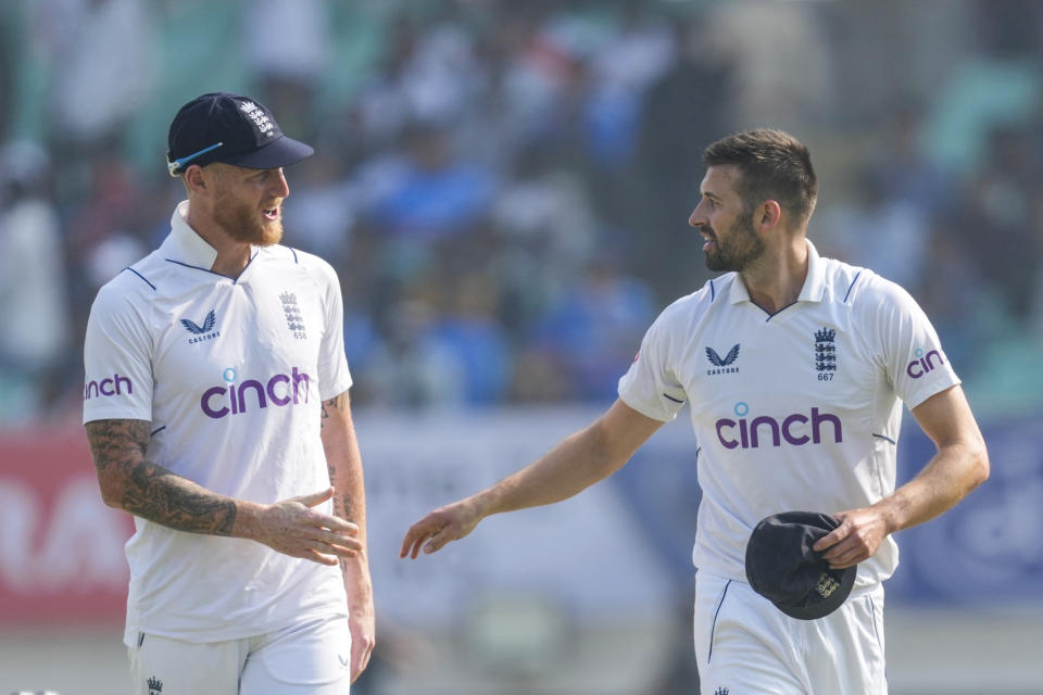 England's captain Ben Stokes, left talks with Mark Wood on the first day of the third cricket test match between India and England in Rajkot, India, Thursday, Feb. 15, 2024. (AP Photo/Ajit Solanki)