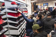 Cleveland Guardians fans look at new merchandise at the opening of the team store in Cleveland, Friday, Nov. 19, 2021, in Cleveland. It's Day One for the Guardians, who will put caps, jerseys and other merchandise on sale to the public for the first time since dropping the name Indians, the franchise's identity since 1915. (AP Photo/Ken Blaze)